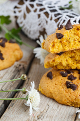 Cookies with chocolate on old books with fresh flowers.selective focus
