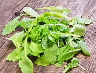 fresh arugula salad on wooden table