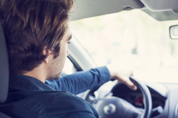 Young man driving car