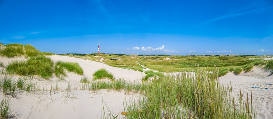 Dune landscape with lighthouse at North Sea