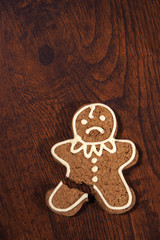 Sad gingerbread man - cookie with a broken leg. - 93498210