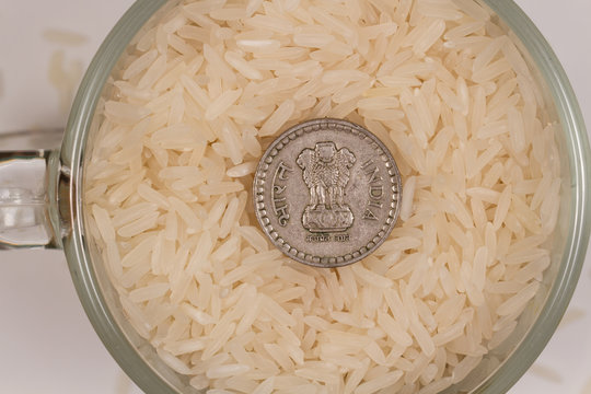 White steamed rice in a glass mug and five Indian rupees. Photo is ideal for website design or Indian sushi bar