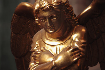 golden angel in the sunlight (antique statue)