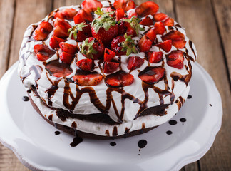 Chocolate cake with whipped cream and strawberries.selective focus