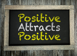 Positive Attracts Positive written on chalkboard