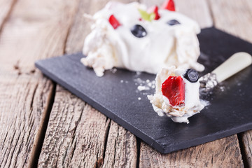 Pavlova meringue cake with cream and berry.selective focus