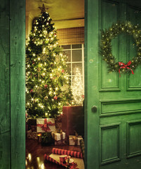 Door opening into a room with Christmas tree