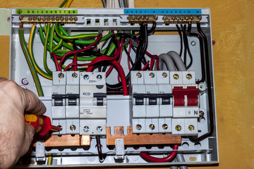 electrical engineer wiring a distribution board