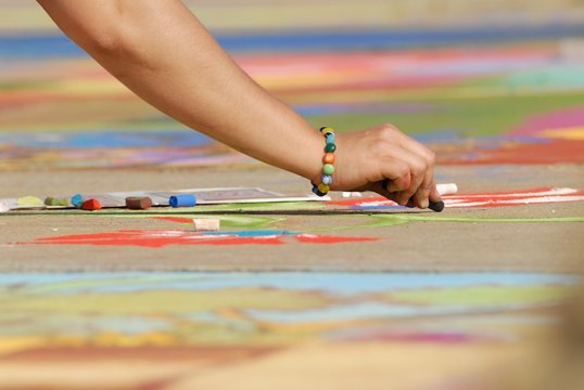 Fototapeta Madonnari- Street art with chalk, woman hand woman hand