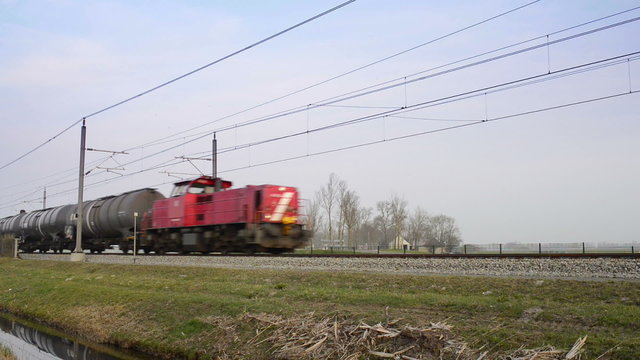 Freight train passing on an elevated railroad track in the country side.