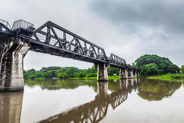 Fototapeta na wymiar Railway Bridge in the rain cloud, River Kwai, Kanchanaburi, Thailand