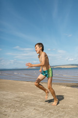 Fototapeta na wymiar Boy running on the beach