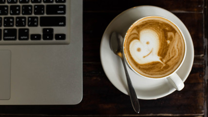 Hot art Latte Coffee in a cup on wooden table and Coffee shop bl