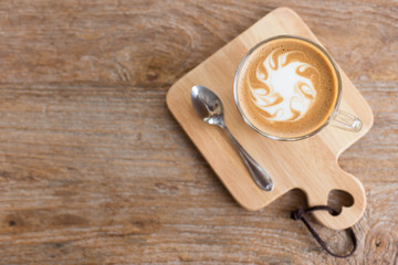 Hot art Latte Coffee in a cup on wooden table and Coffee shop bl