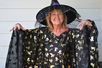 Mature female wearing her halloween costume outside.