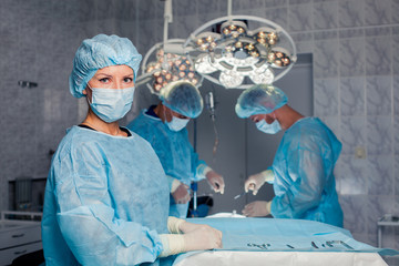 Team surgeon at work in operating room. breast augmentation
