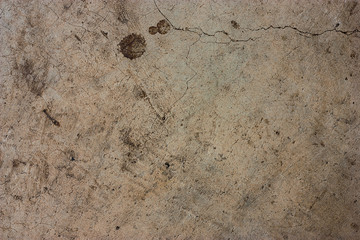 Cement floors are old and dirty.