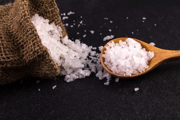 salt crystals on black stone plate background , selective focus