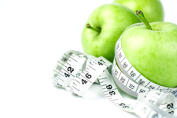 green apple with Measuring tape in diet concept 