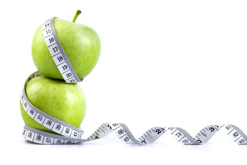 green apple with Measuring tape  in diet concept 
