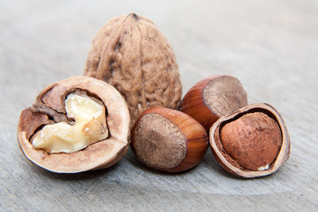 Walnuts and hazelnuts. All on wooden background