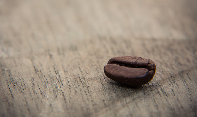 Fototapeta na wymiar Roasted coffee beans on wooden background