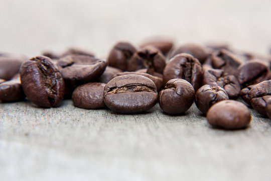 Fresh roasted coffee beans on wooden background