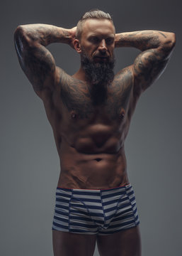 Fashinable mude tattooed man with beard.