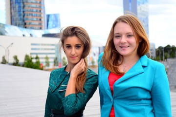 Two girls in blue sky and clouds background