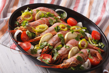 Boiled prawns with chilli, herbs and vegetables close-up. horizontal
