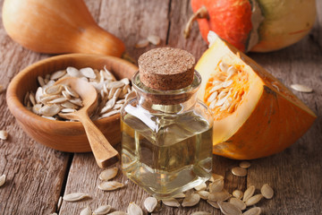 Healthy pumpkin seed oil close-up with the ingredients. horizontal   © FomaA