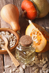 pumpkin oil on the table close-up and ingredients. Vertical
