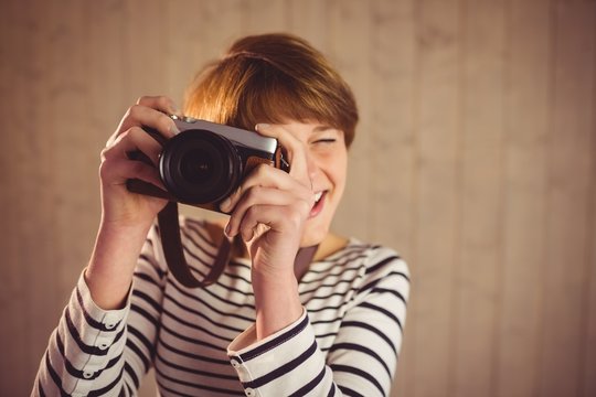 Pretty young woman taking photos