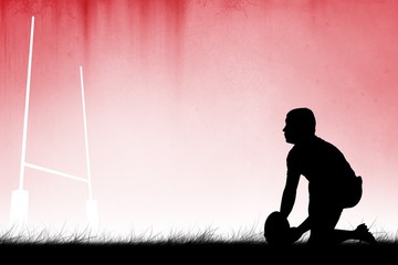 Composite image of silhouette of rugby player