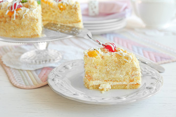 Peace of tasty Butter cake on plate, on color wooden background