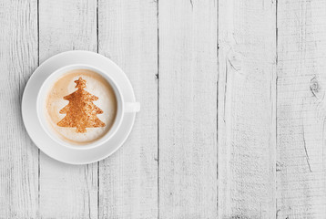 coffee mug with christmas tree shape on white wood table © Andrey Kuzmin