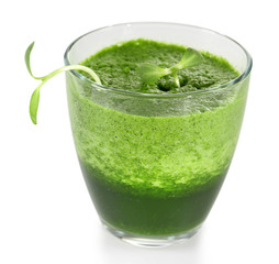 Glass of green vegetable juice with young sunflower sprouts isolated on white