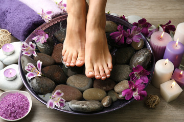 Female feet at spa pedicure procedure