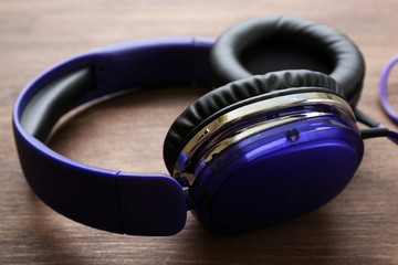 Headphones on wooden background