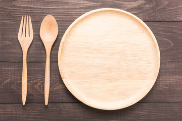 Set of fork,spoon and dish wood on wooden table.