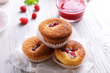 Delicious cupcakes with berries on table close up
