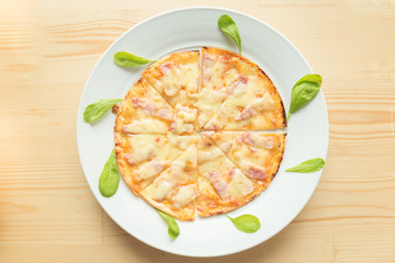 Rustic pizza on wooden background. Top view