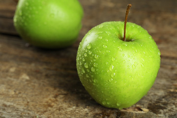 Ripe green apples on wooden table close up