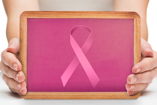Composite image of females hands showing pink board