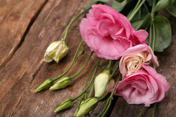 Beautiful eustoma on wooden background