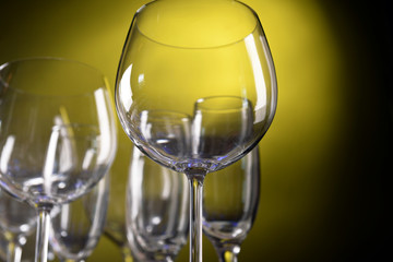 Empty wine glasses on yellow background