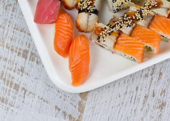 Sushi set in a special wooden plate over vintage background