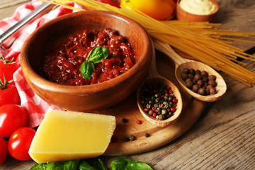 Pasta spaghetti with tomatoes, sauce bolognese, cheese and basil on rustic wooden  background