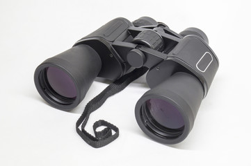 Black binoculars insulated on light background
