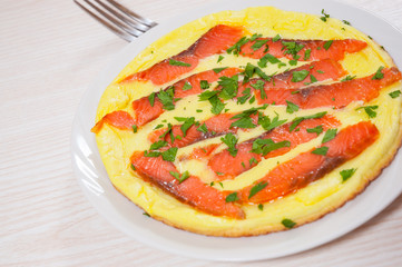 omelet with smoked salmon in a frying pan